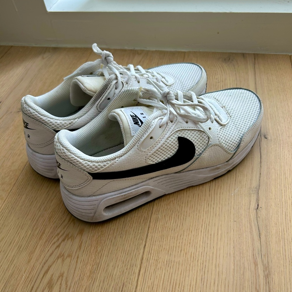 Nike white sneakers with black symbol